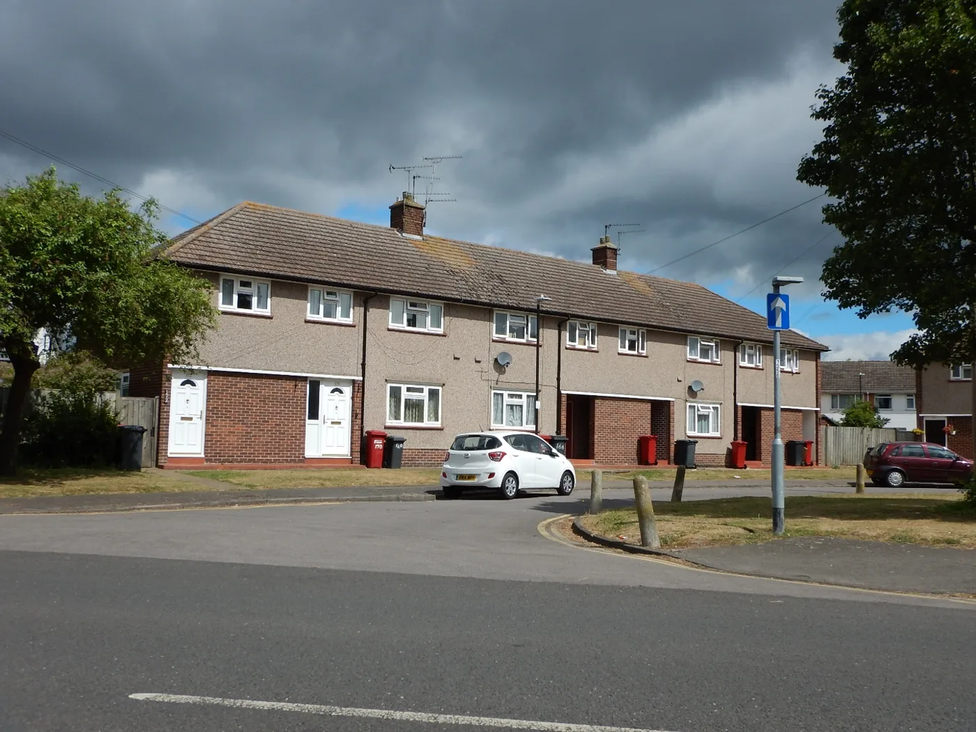 Grey and red bins outside houses on Lower Cippenham Lane, Slough